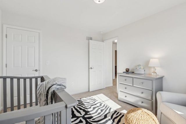 bedroom featuring light carpet, visible vents, and baseboards