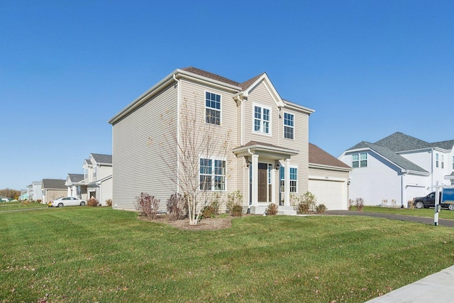 view of front of home with a residential view, an attached garage, driveway, and a front lawn