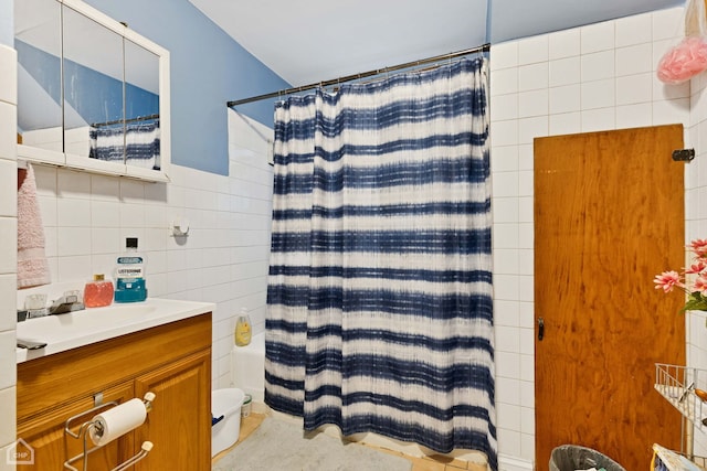 full bathroom with toilet, tile walls, and vanity