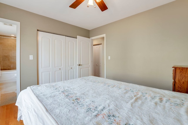 bedroom with visible vents, ensuite bathroom, a closet, light wood finished floors, and ceiling fan