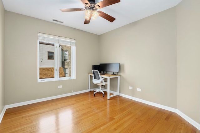 office featuring visible vents, ceiling fan, light wood-type flooring, and baseboards