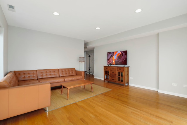 unfurnished living room featuring recessed lighting, visible vents, light wood finished floors, and baseboards