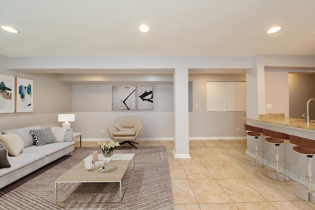 living room with light tile patterned floors, baseboards, and recessed lighting