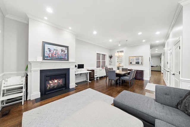 living room featuring dark wood-style flooring, wainscoting, a fireplace with flush hearth, and recessed lighting