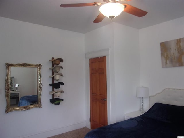 unfurnished bedroom featuring a ceiling fan and carpet