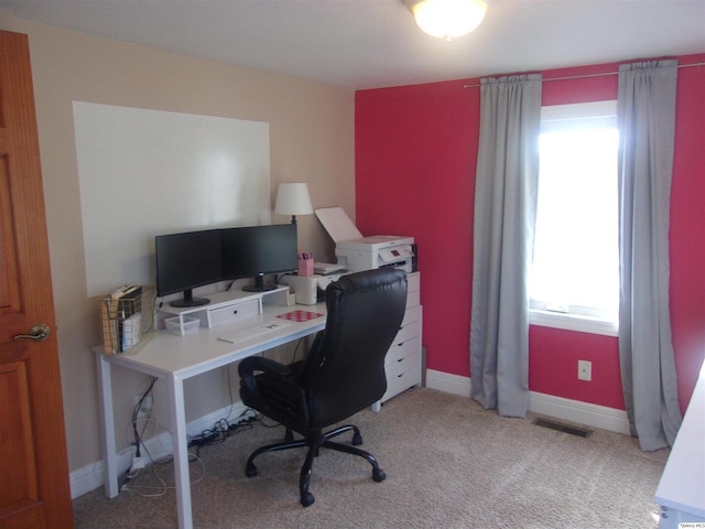 office space featuring carpet floors, visible vents, and baseboards