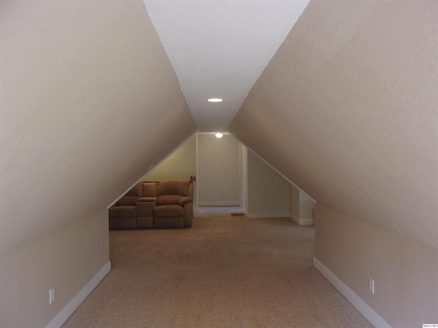 bonus room with carpet floors, baseboards, and lofted ceiling