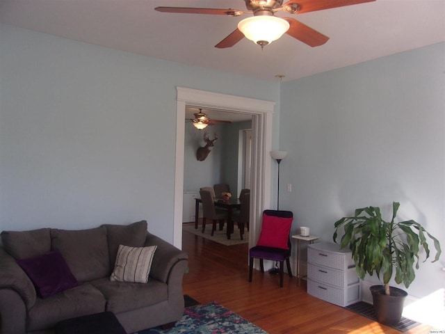 living room featuring a ceiling fan and wood finished floors