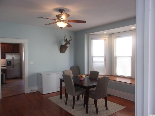 dining area featuring ceiling fan, light wood-type flooring, and baseboards