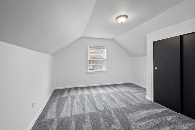 bonus room with carpet, vaulted ceiling, and baseboards