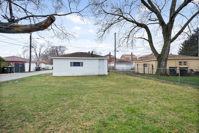 view of yard with an outbuilding and fence