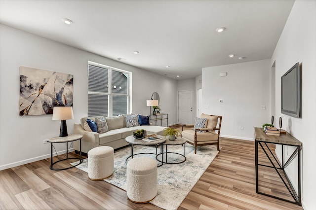 living room with recessed lighting, light wood-type flooring, and baseboards