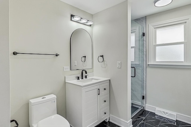 bathroom with baseboards, toilet, a stall shower, marble finish floor, and vanity