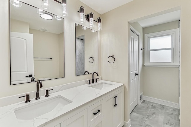 full bath with a sink, visible vents, baseboards, and marble finish floor