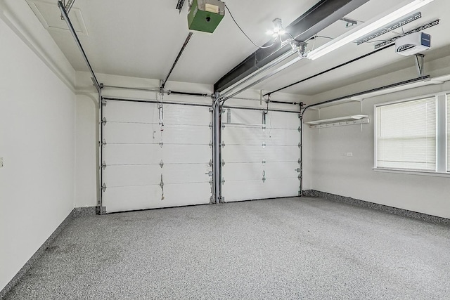 garage with baseboards and a garage door opener