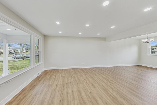 spare room with visible vents, baseboards, recessed lighting, light wood-style floors, and a notable chandelier