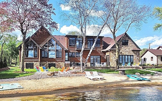 view of front of property with stone siding and stairs