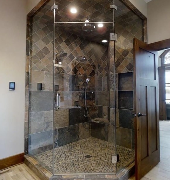 bathroom featuring a shower stall, baseboards, and wood finished floors