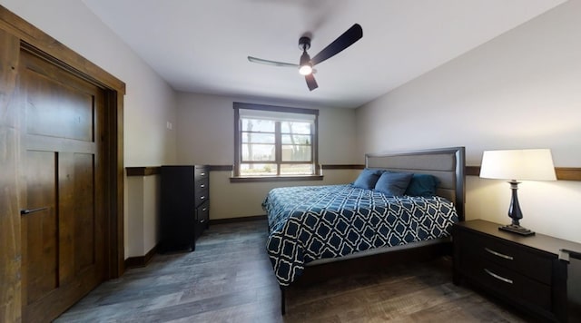 bedroom featuring dark wood-style floors, ceiling fan, and baseboards