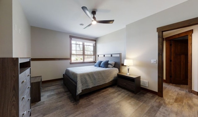 bedroom with a ceiling fan, baseboards, and wood finished floors