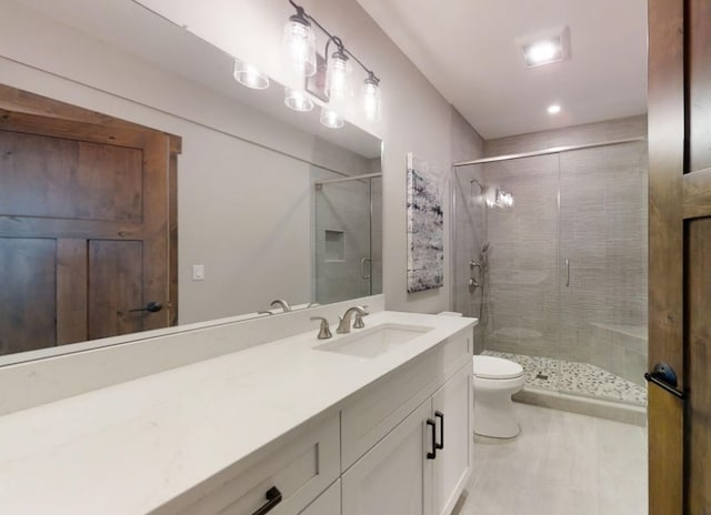 full bath with toilet, a shower stall, and vanity