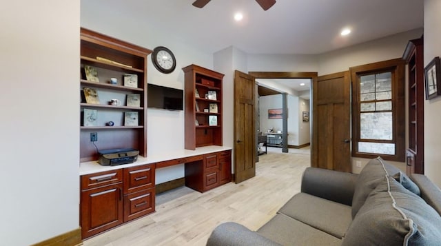 office area featuring recessed lighting, a ceiling fan, baseboards, built in study area, and light wood finished floors