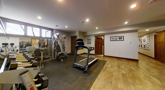 workout room with light wood-type flooring, baseboards, and recessed lighting