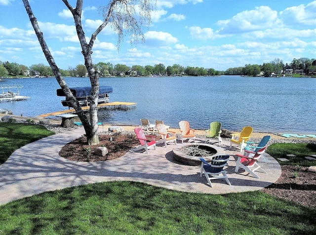 water view featuring a boat dock and an outdoor fire pit