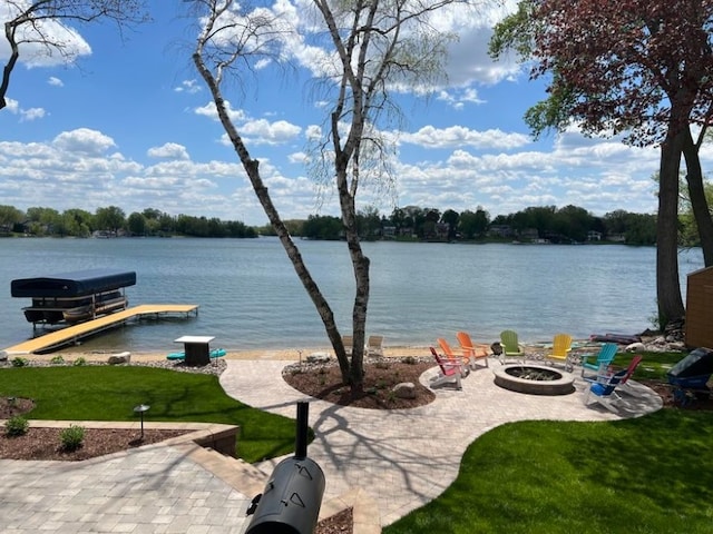 water view featuring a fire pit, a boat dock, and boat lift