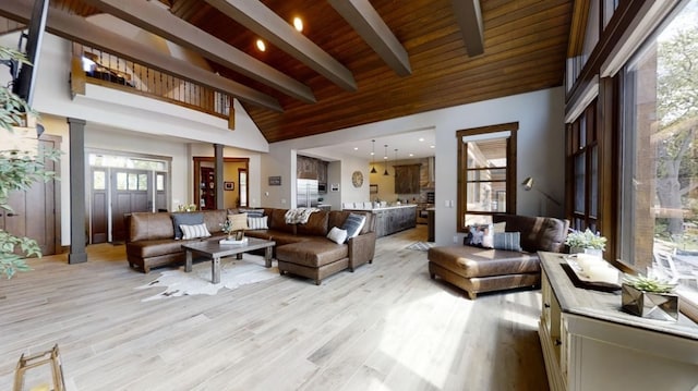 living area with decorative columns, wooden ceiling, light wood-style flooring, beamed ceiling, and high vaulted ceiling