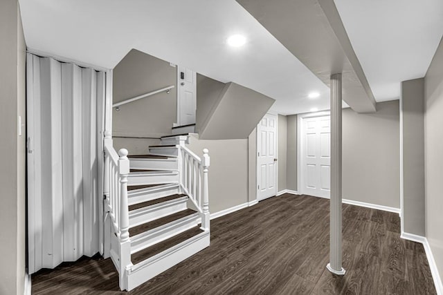 finished basement featuring stairway, recessed lighting, wood finished floors, and baseboards