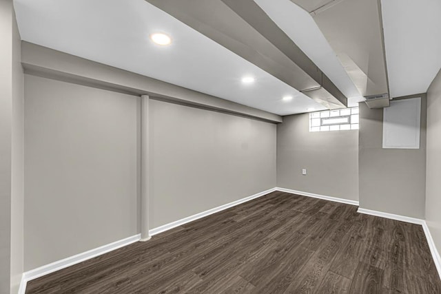 basement with recessed lighting, dark wood finished floors, and baseboards