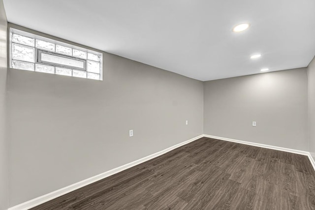 basement with recessed lighting, dark wood finished floors, and baseboards