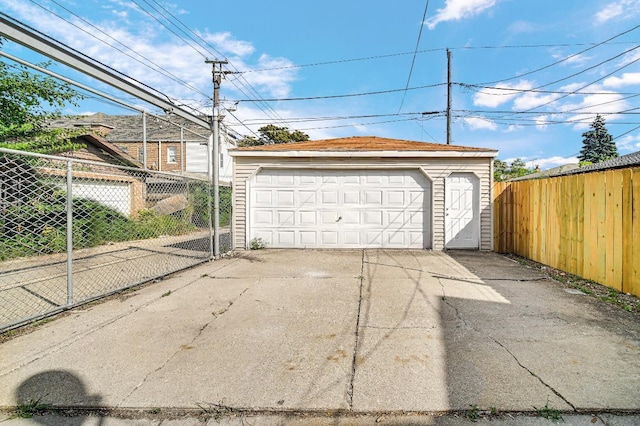 detached garage featuring fence