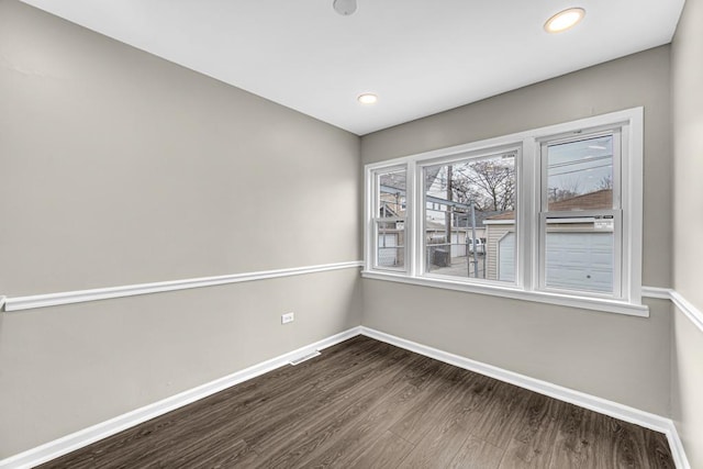 empty room with visible vents, baseboards, dark wood-type flooring, and recessed lighting