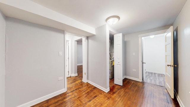 unfurnished bedroom featuring wood-type flooring and baseboards