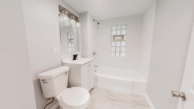 bathroom featuring marble finish floor, bathtub / shower combination, toilet, a sink, and baseboards