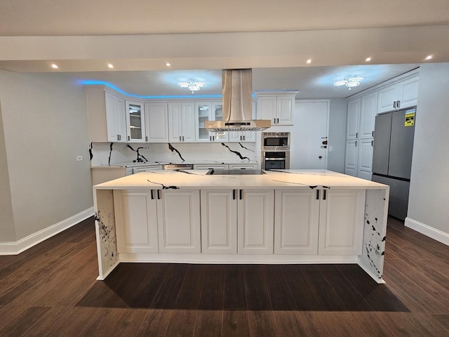 kitchen with island range hood, white cabinets, glass insert cabinets, stainless steel appliances, and light countertops