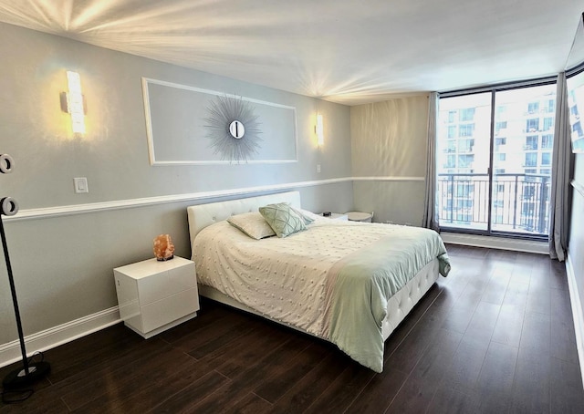 bedroom with wood finished floors and baseboards