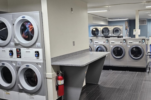 community laundry room featuring stacked washer and dryer and separate washer and dryer