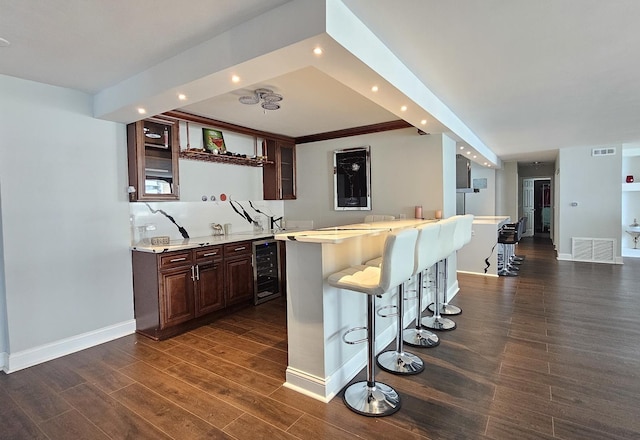 bar featuring recessed lighting, beverage cooler, visible vents, baseboards, and dark wood finished floors