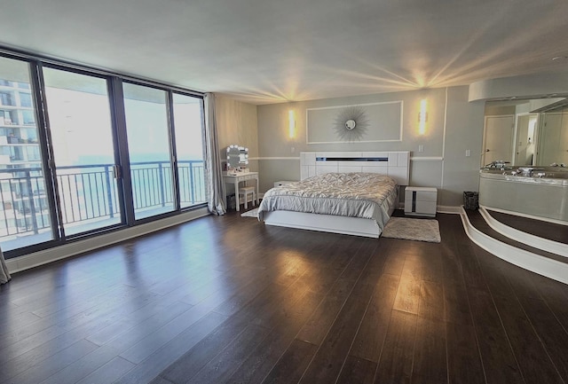 bedroom featuring access to exterior and wood finished floors