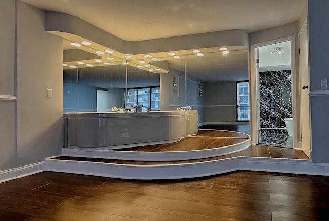 bathroom featuring wood finished floors and baseboards