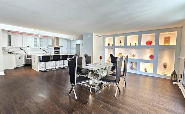 dining room featuring dark wood-style floors and visible vents