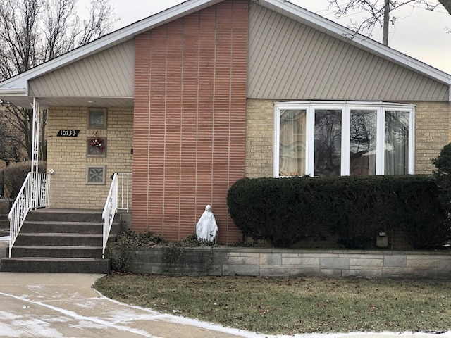 view of front of house featuring brick siding