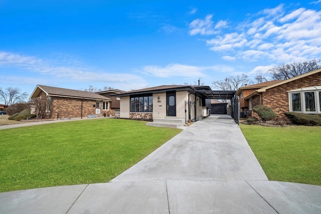 view of front of house with driveway, a front lawn, and brick siding