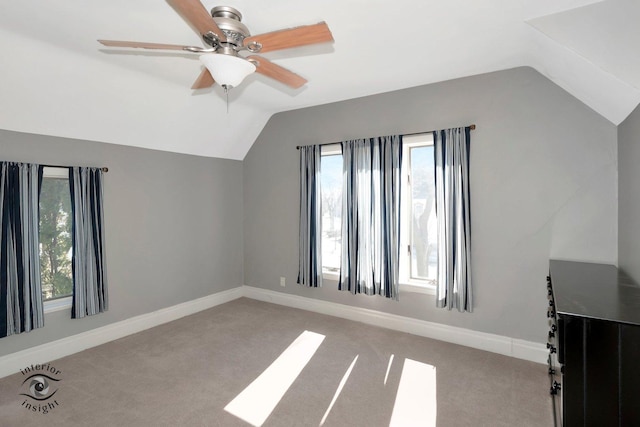 bonus room with vaulted ceiling, carpet, and a healthy amount of sunlight