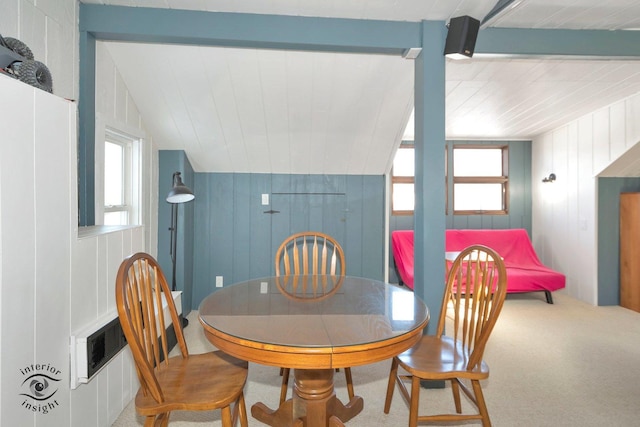 dining space with vaulted ceiling with beams and carpet floors