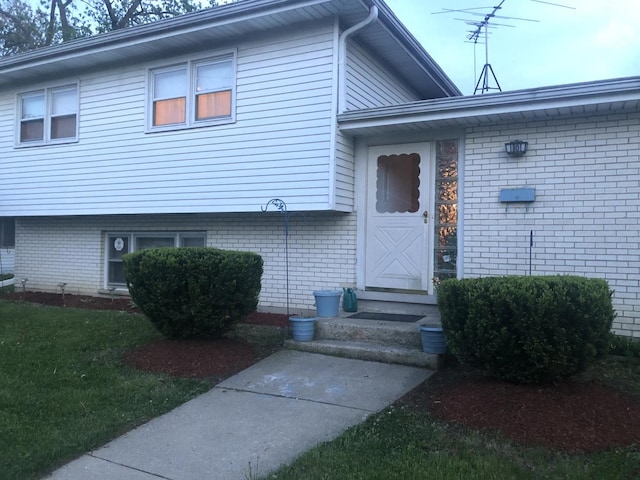 doorway to property featuring a yard