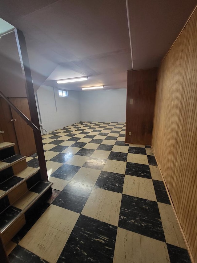 basement featuring stairs and tile patterned floors